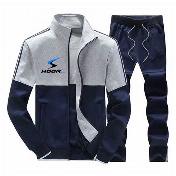 Navy blue and grey color block men’s tracksuit set with zip-up jacket and drawstring pants.
