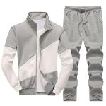 Light grey and white color block men’s tracksuit set with zip-up jacket and drawstring pants.
