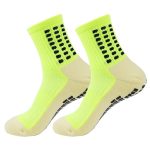 Pair of neon yellow anti-slip performance grip socks with black traction dots.