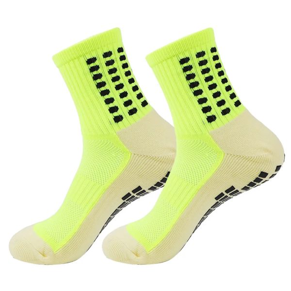 Pair of neon yellow anti-slip performance grip socks with black traction dots.