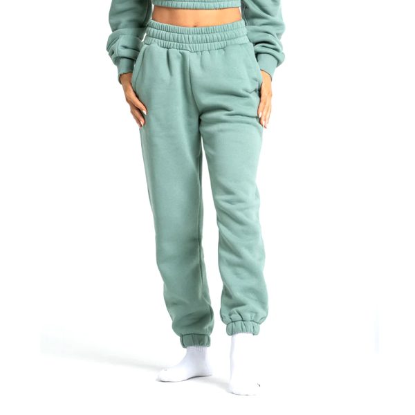 Women’s mint green fleece joggers with high waist, side pockets, and elastic cuffs.