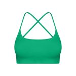 Emerald green seamless sports bra with crisscross strappy back for yoga and fitness.