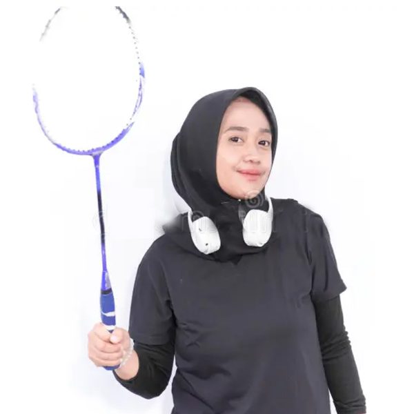 Hijab woman in black modest sportswear holding a badminton racket with headphones around her neck.
